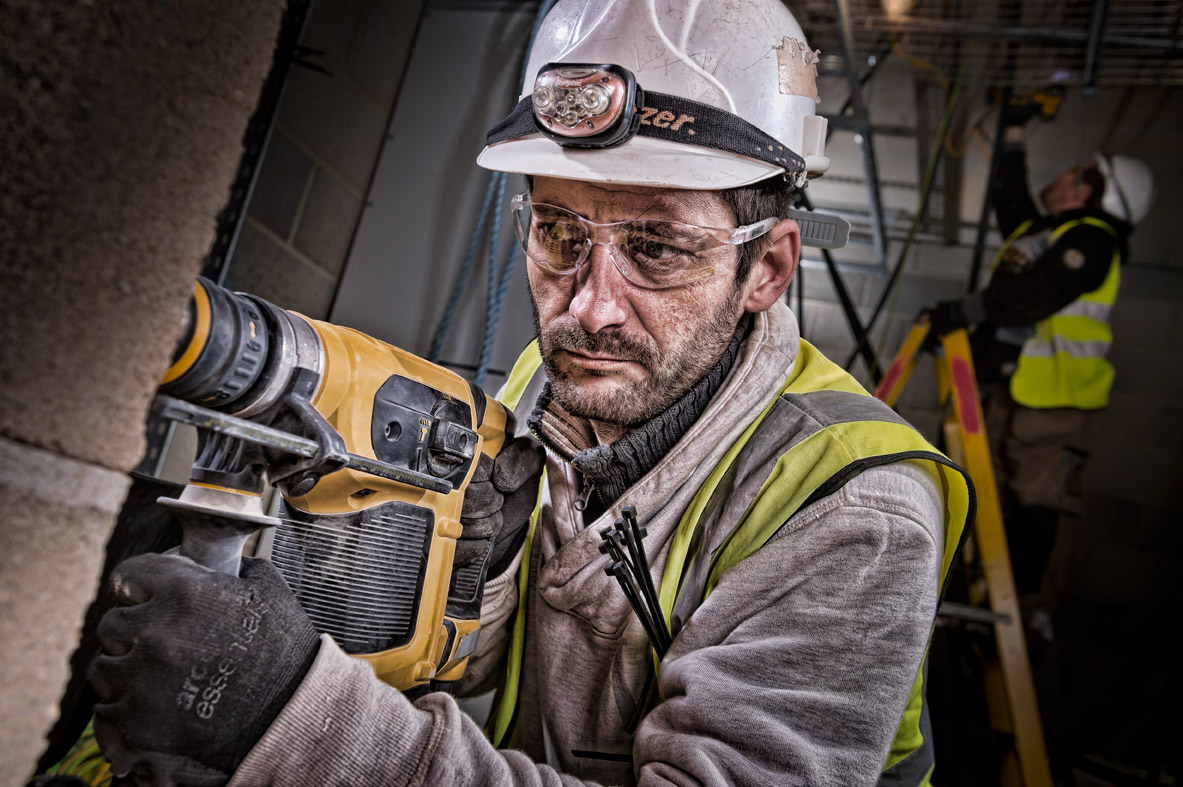 Using a drill on a London construction site