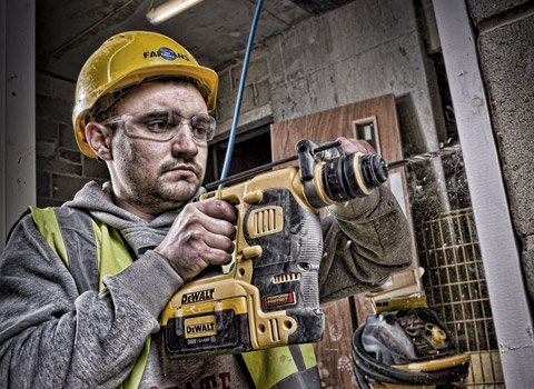 Construction worker using a deWalt drill