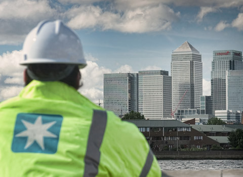 Maersk worker looking over The Thames towards Canary Wharf