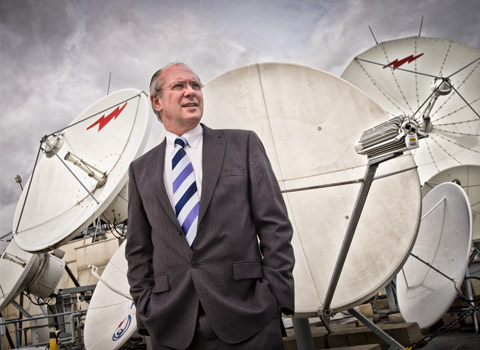 TV executive in front of satallite dishes on a roof in London