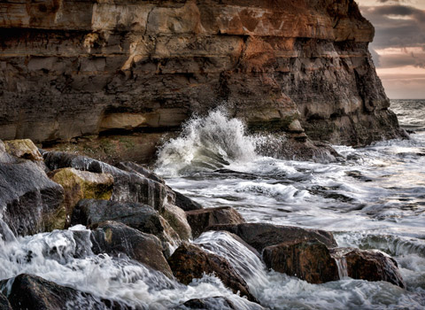 Wave hitting a cliff at Staithes, North Yorkshire
