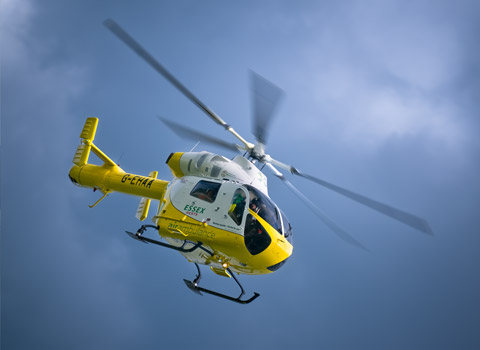 Yellow helicopter in a blue sky