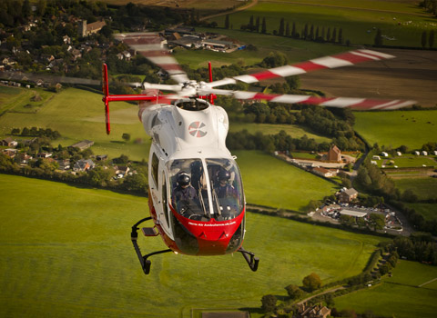 Helicopter in flight photographed from another helicopter