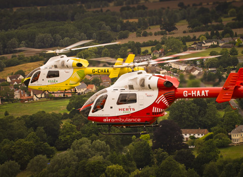 Two helicopters shot from another helicopter in flight