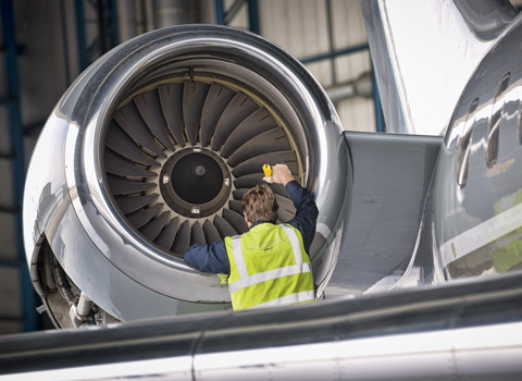 Maintenance on a jets engine in a hanger