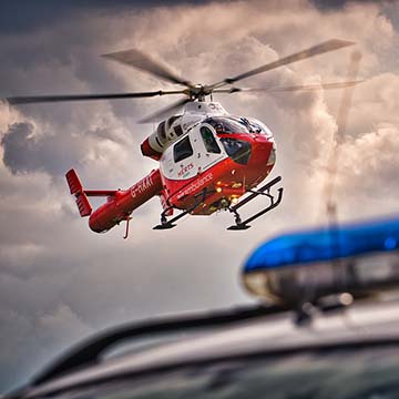 The Hertfordshire air ambulance hovering over the blue lights of a police car