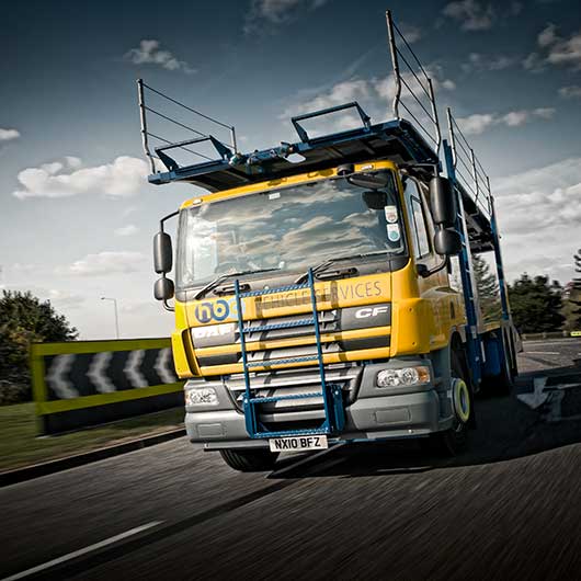 Tracking picture of a lorry driving around a roundabout in Essex