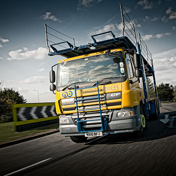 Lorry driving on a road photographed from another car