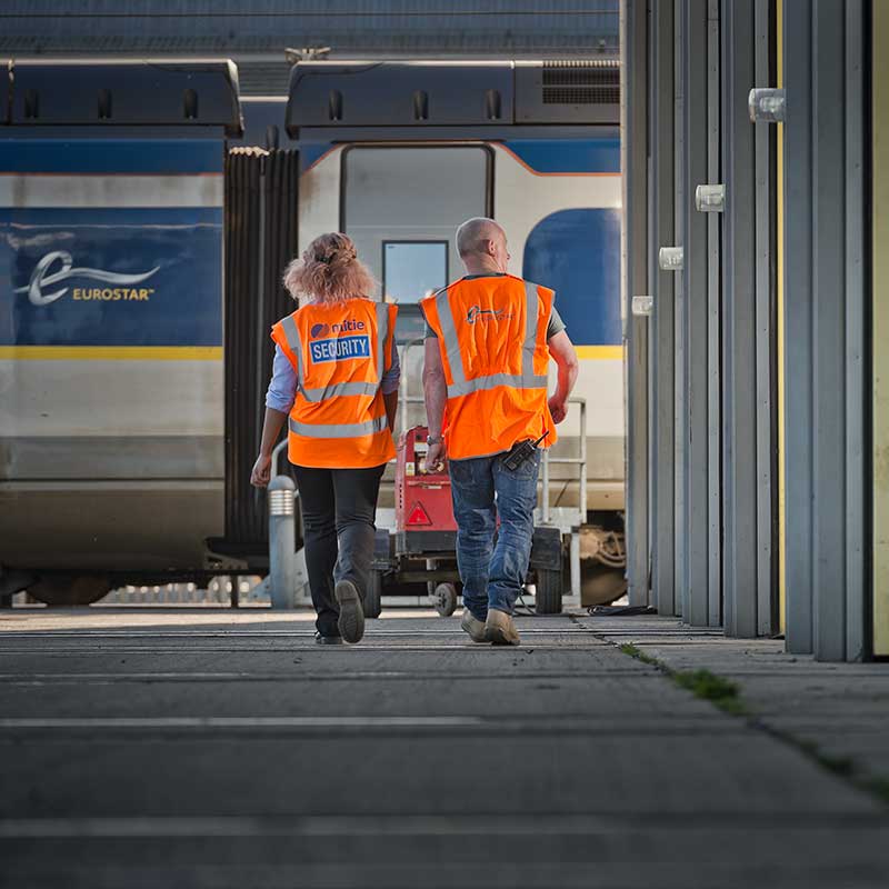 Two workers walking towards an Eurostar train