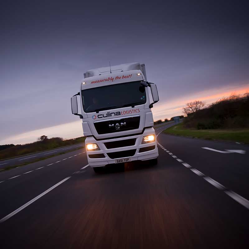 A lorry on a road photographed from another car