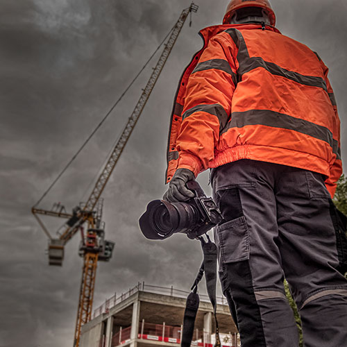 Construction photographer in Hi-viz on a site in the UK