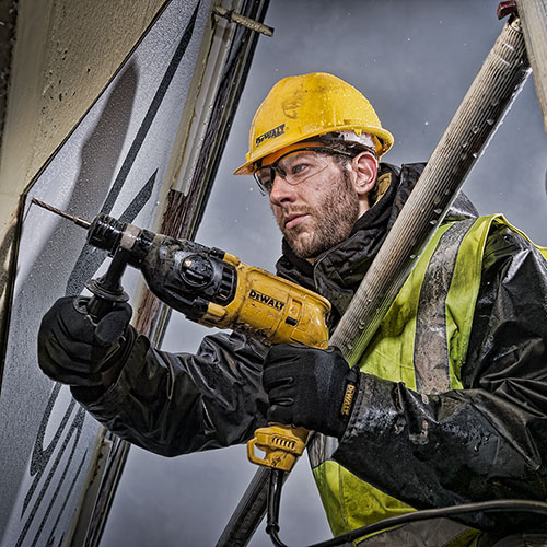 An example of commercial photography showing a worker with a deWalt drill at a London construction site