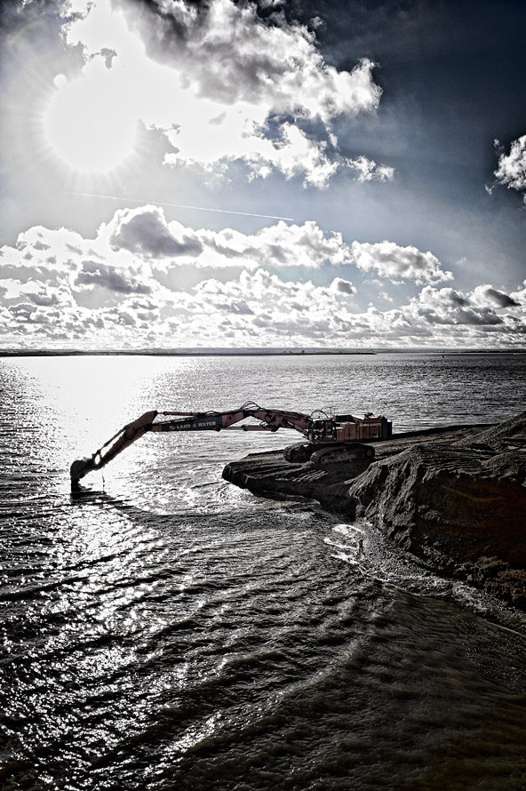 Excavator working at the coast