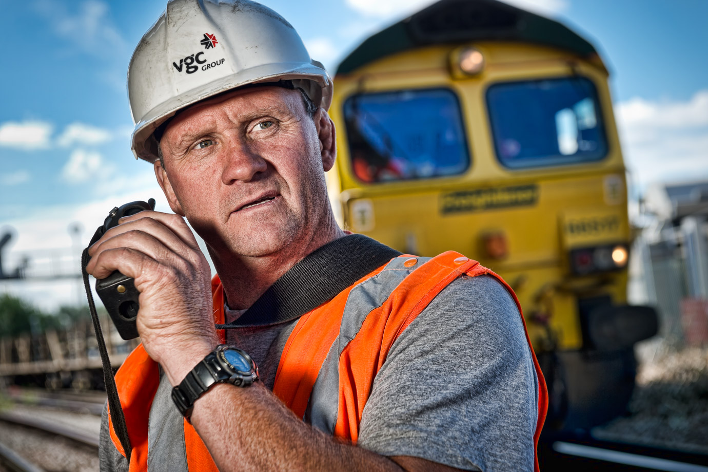 Rail worker with a locomotive in the background