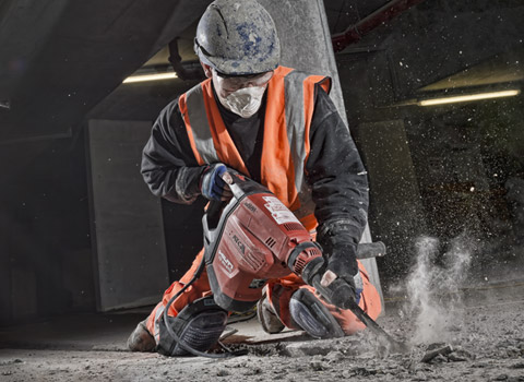 Using a power tool on a construction site in London