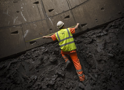 Construction worker at bottom of deep ecavation