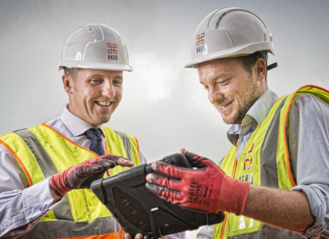 Workers with a tablet on a construction site