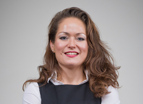 Female office worker photographed on a plain background