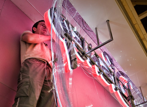 Fitting a sign in a shopping centre in Essex