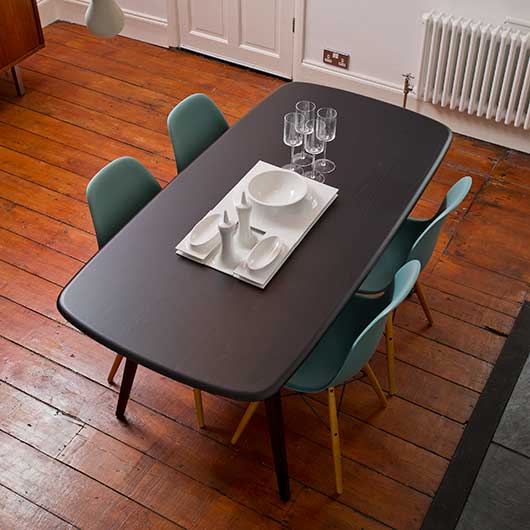 A dining room table on a wooden floor in a house in east London