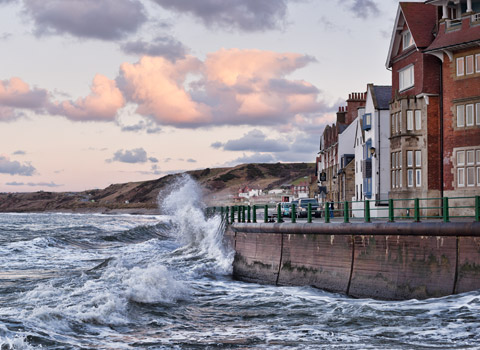 Wave hitting the seawall at Sandsend, North Yorkshire