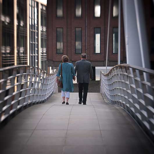 A couple walking over a bridge
