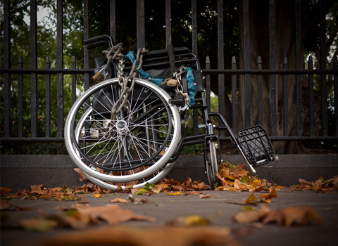 Wheelchair chained to railings