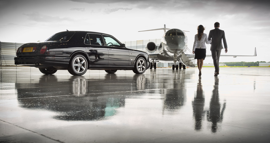 Two people approaching an airplane for a private flight