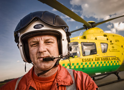 Paramedic of the Essex Air Ambulance with the helicopter in the background