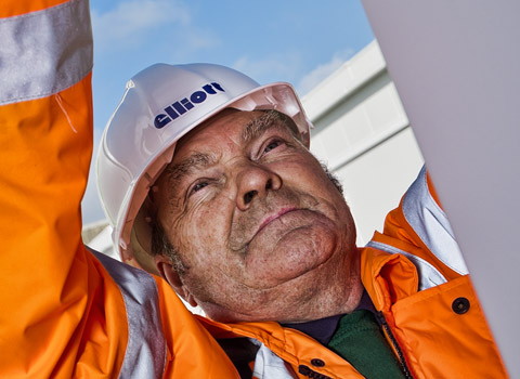 Portrait of a construction worker fixing chains on a crane