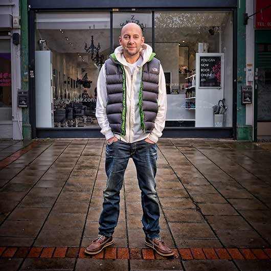 Full length portrait of a hair salon owner outside their premises