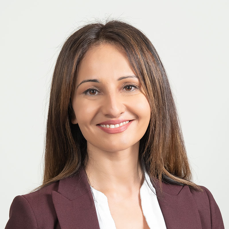 Professional woman looking relaxed, happy and confident in her professional business portrait.